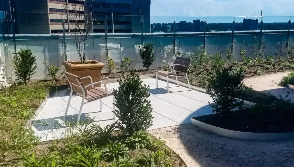 landscaping on a green roof in Louisville, kentucky. Two chairs and a planter box with a tree.
