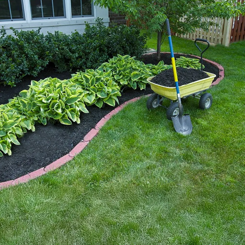 Fransen Group Landscaping Company mulching during a spring fall cleanup